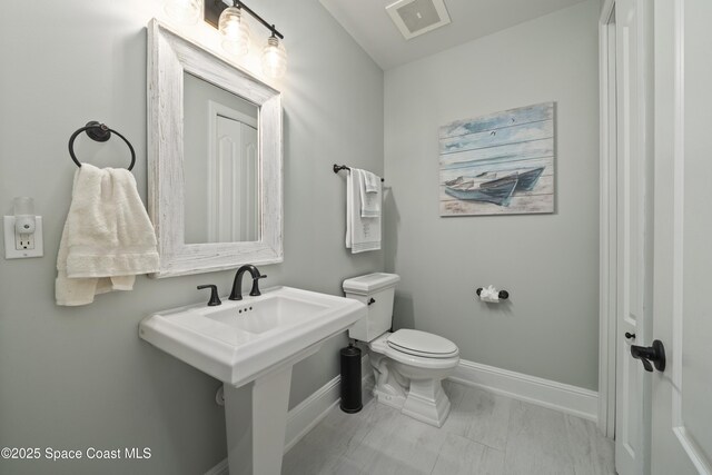 4955 Dixie Hwy NE Unit 801, Palm Bay, FL 32905 - half bathroom with a sink, visible vents, baseboards, and toilet