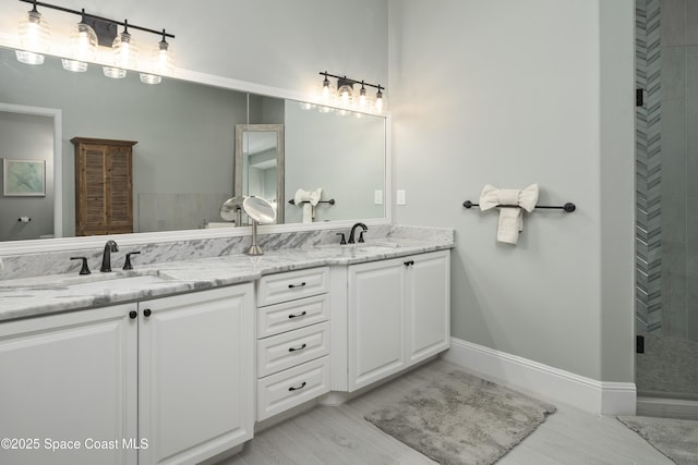 4955 Dixie Hwy NE Unit 801, Palm Bay, FL 32905 - bathroom featuring double vanity, baseboards, a tile shower, and a sink