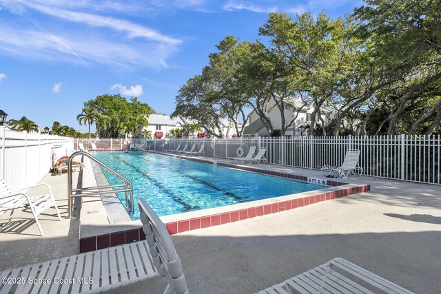 community pool featuring a patio area and fence