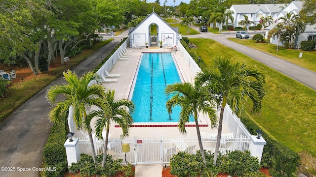 pool featuring a fenced front yard and a gate