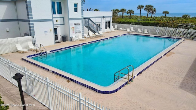 community pool featuring a patio and fence