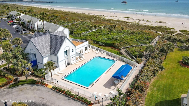 birds eye view of property with a beach view and a water view