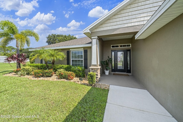 doorway to property featuring a yard