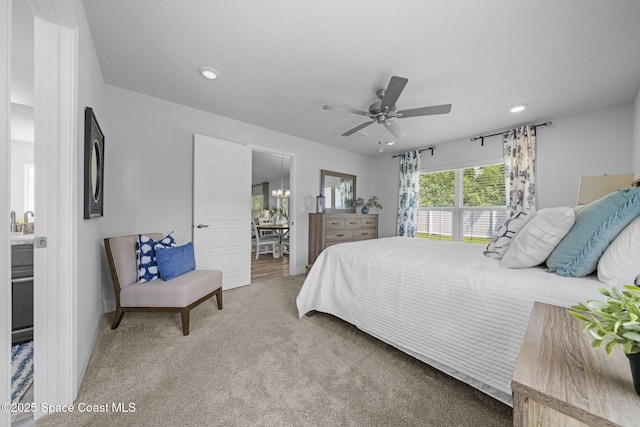 bedroom with connected bathroom, ceiling fan, and carpet