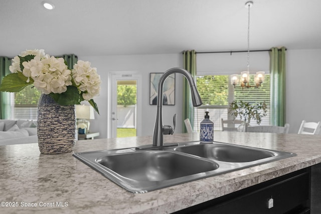 kitchen featuring an inviting chandelier, sink, and hanging light fixtures