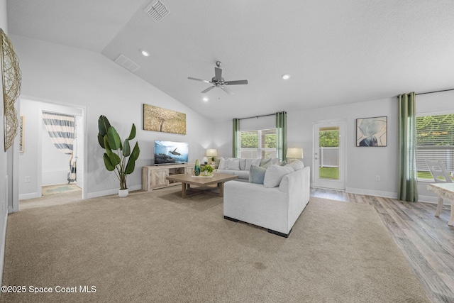 living room featuring ceiling fan, light wood-type flooring, and high vaulted ceiling