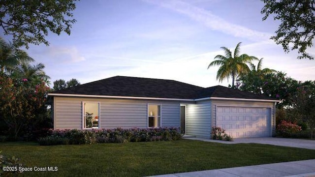 ranch-style home featuring a garage and a yard