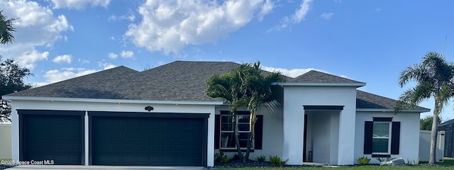 view of front of property featuring a garage and a front lawn