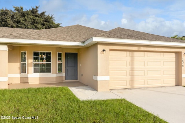 ranch-style house featuring a garage and a front yard