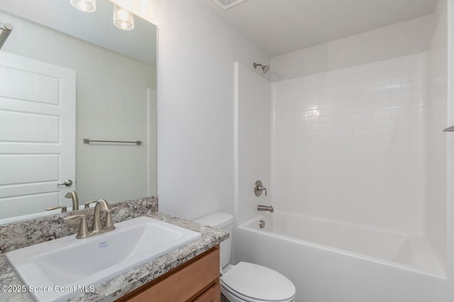 full bathroom featuring vanity, bathtub / shower combination, and toilet