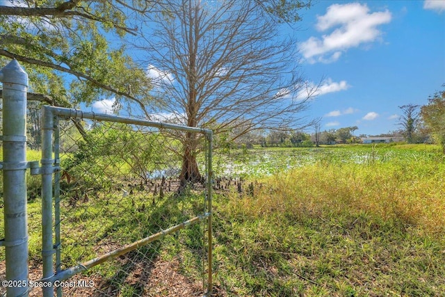 view of yard featuring fence and a rural view