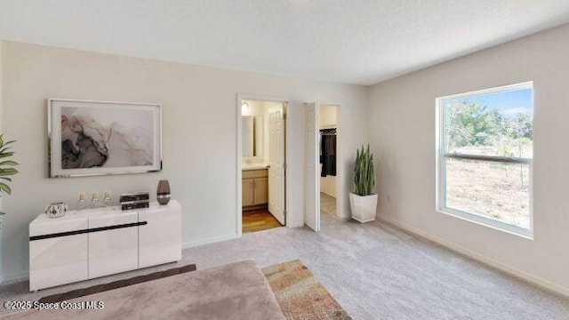 carpeted bedroom with connected bathroom