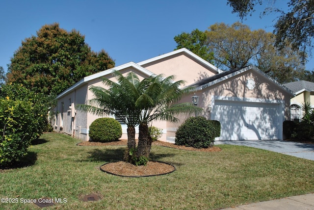 view of front of property featuring a garage, a front yard, concrete driveway, and stucco siding