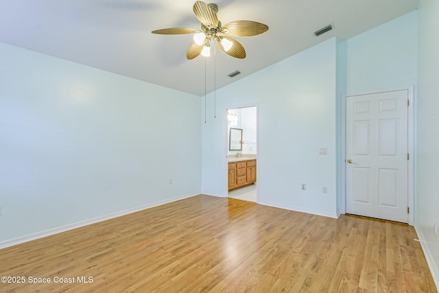 unfurnished bedroom with light wood finished floors, baseboards, visible vents, and vaulted ceiling