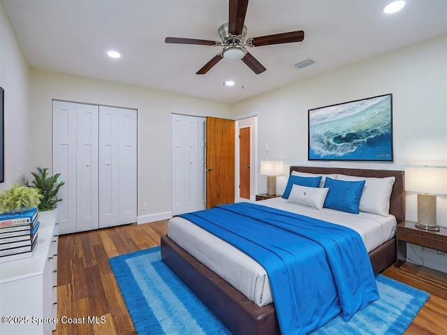 8075 134th St, Sebastian, FL 32958 - bedroom with multiple closets, ceiling fan, and dark hardwood / wood-style flooring