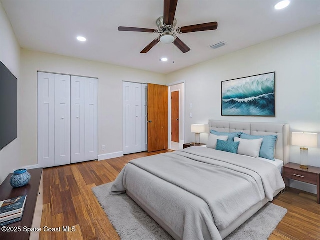8075 134th St, Sebastian, FL 32958 - bedroom with multiple closets, ceiling fan, and hardwood / wood-style floors