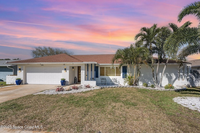 ranch-style house featuring a porch, a garage, driveway, stucco siding, and a front lawn