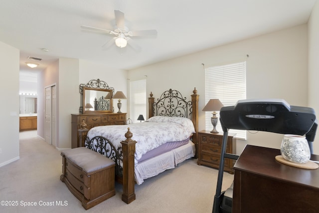 bedroom featuring connected bathroom, light colored carpet, a ceiling fan, visible vents, and a closet