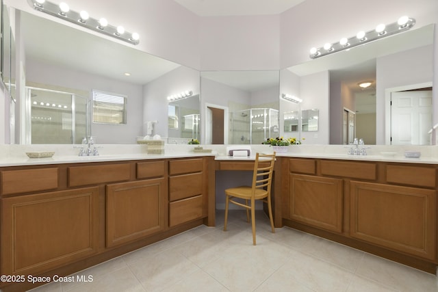 full bath with a stall shower, tile patterned flooring, and vanity