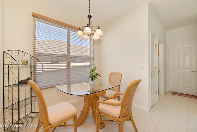 dining space with a notable chandelier, baseboards, and light tile patterned floors