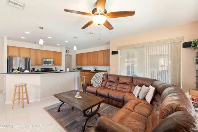 living area with a ceiling fan, recessed lighting, visible vents, and light tile patterned floors