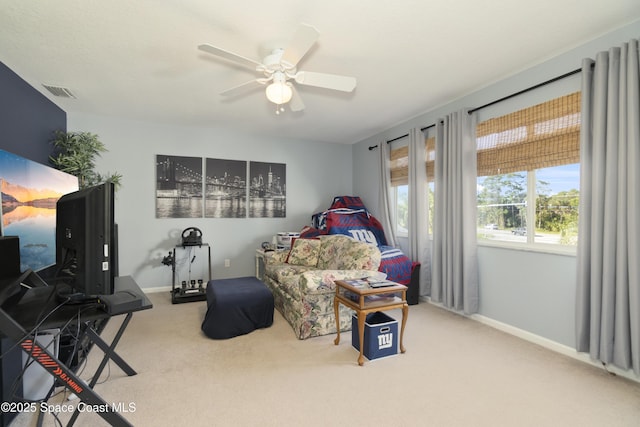 living area featuring carpet floors, ceiling fan, visible vents, and baseboards