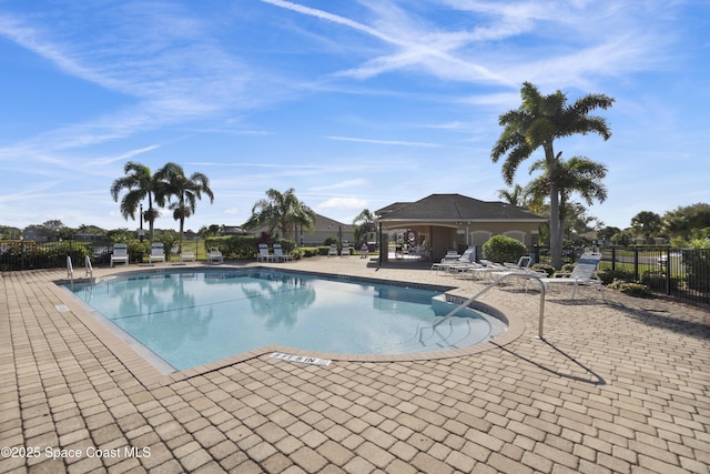 community pool featuring a patio area and fence