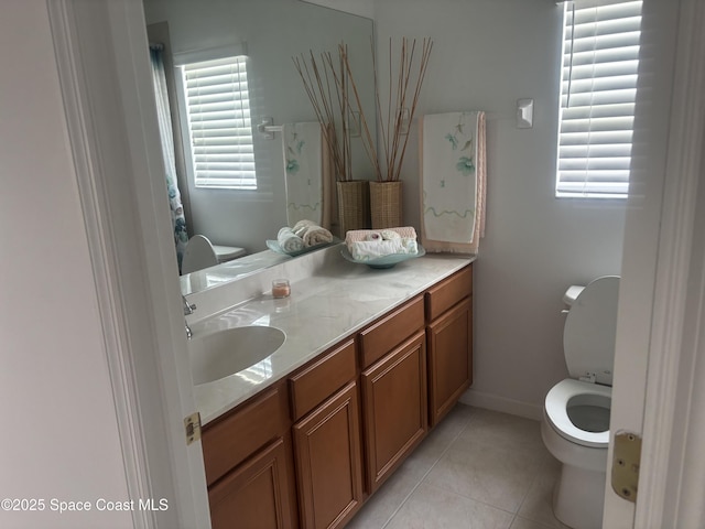 full bathroom with toilet, tile patterned flooring, baseboards, and vanity