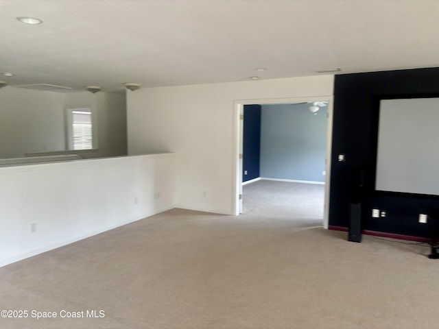 unfurnished room featuring baseboards and light colored carpet