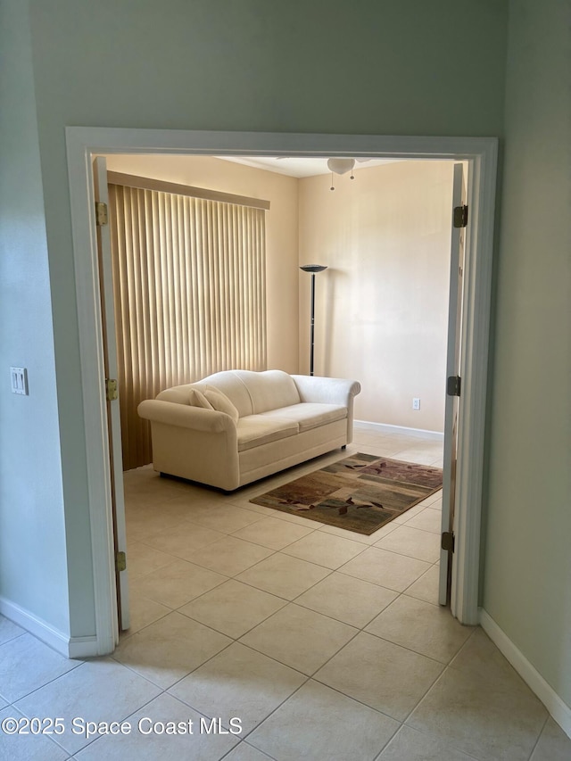 living room featuring light tile patterned floors and baseboards