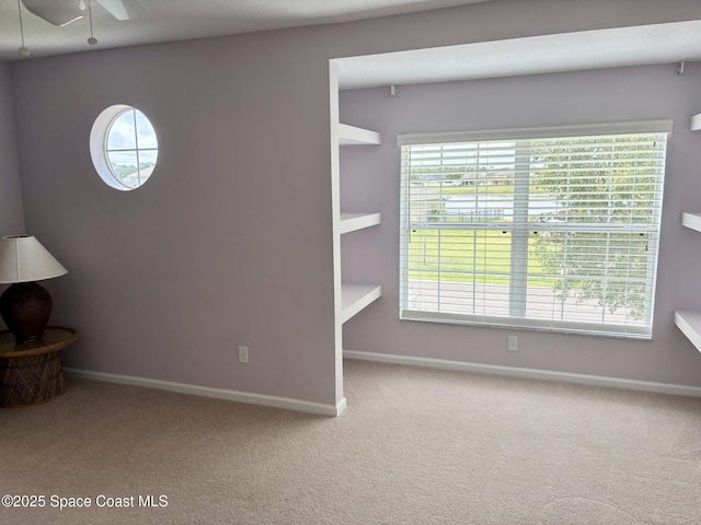 113 Wading Bird Cir SW, Palm Bay, FL 32908 - carpeted spare room featuring plenty of natural light, baseboards, and ceiling fan