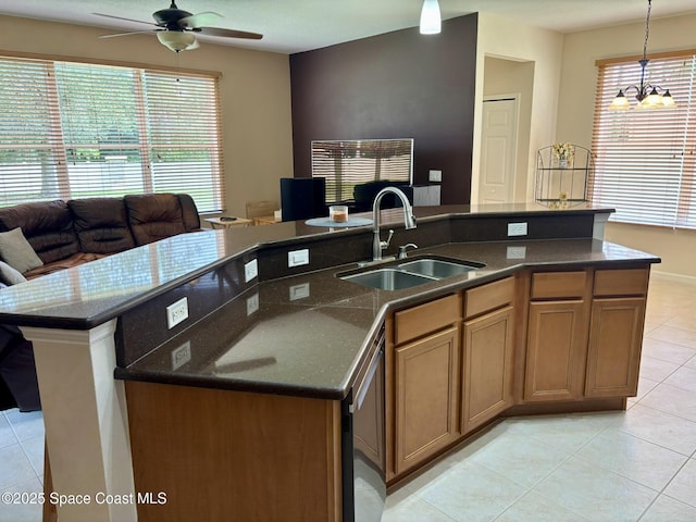113 Wading Bird Cir SW, Palm Bay, FL 32908 - kitchen featuring a sink, open floor plan, light tile patterned floors, a ceiling fan, and an island with sink