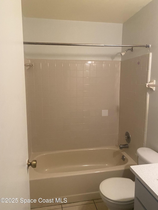 full bathroom featuring vanity, tile patterned flooring, toilet, and tiled shower / bath