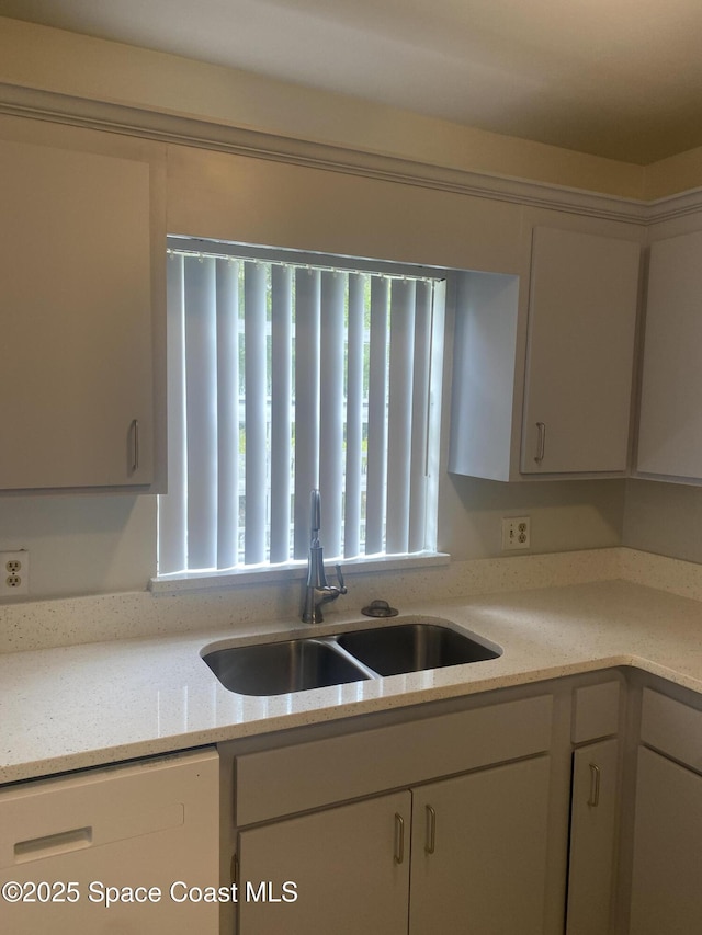 kitchen featuring sink and light stone counters