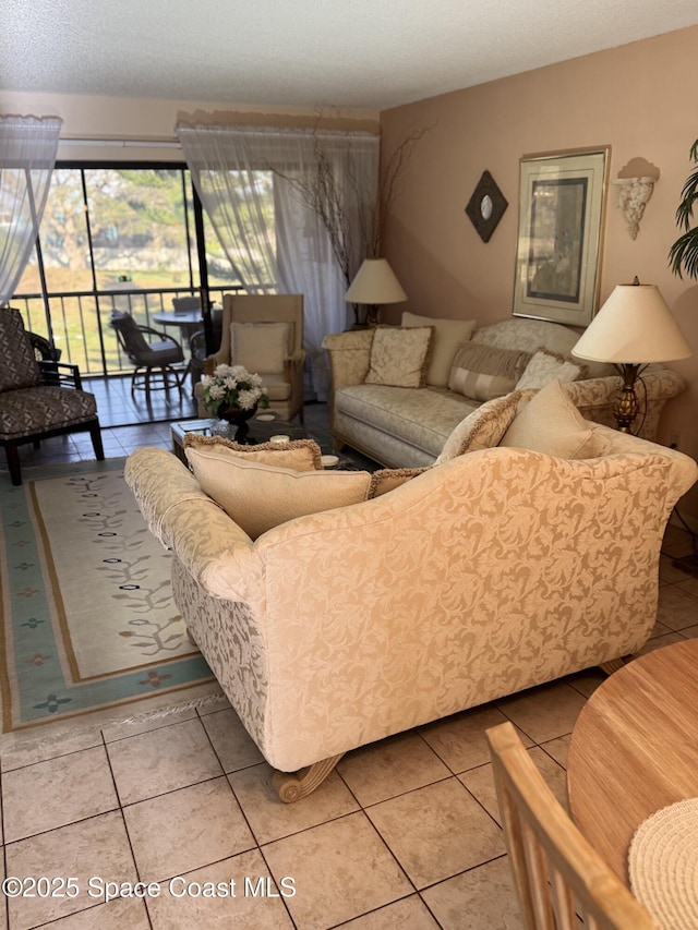 living room featuring a textured ceiling and tile patterned flooring
