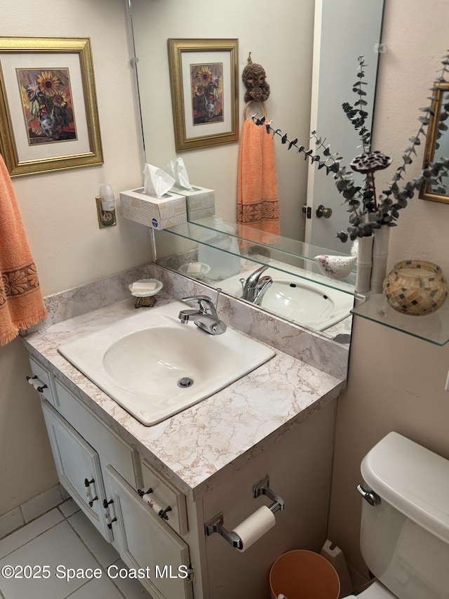 bathroom with vanity, toilet, and tile patterned floors