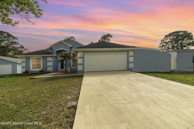 view of front of property featuring a yard and a garage