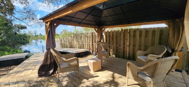 wooden terrace with a water view and a gazebo