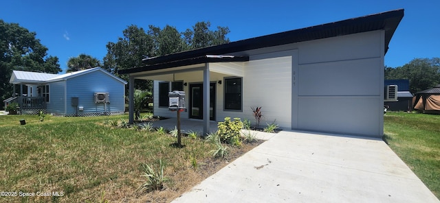 217 Teal Dr, Cocoa, FL 32926 - view of front of property featuring a front lawn, an attached carport, driveway, and a porch