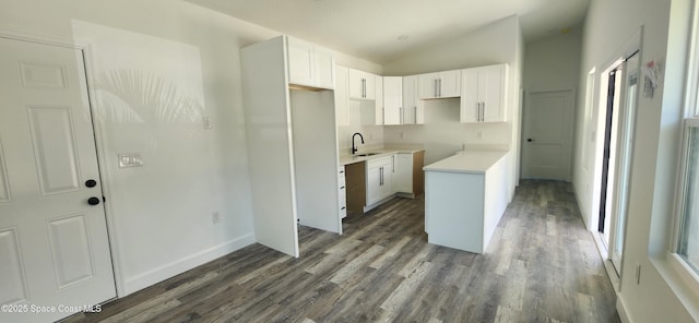 217 Teal Dr, Cocoa, FL 32926 - kitchen featuring vaulted ceiling, dark wood-style flooring, and white cabinets