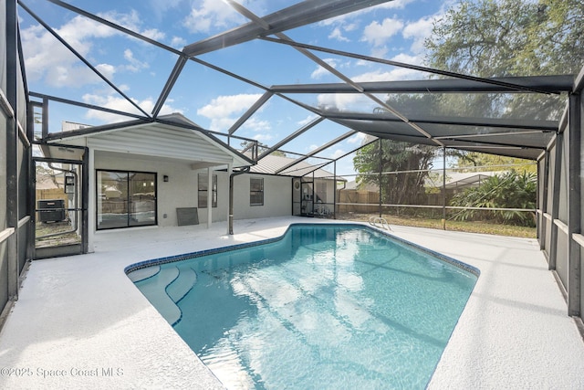 view of pool with central air condition unit, a lanai, and a patio area