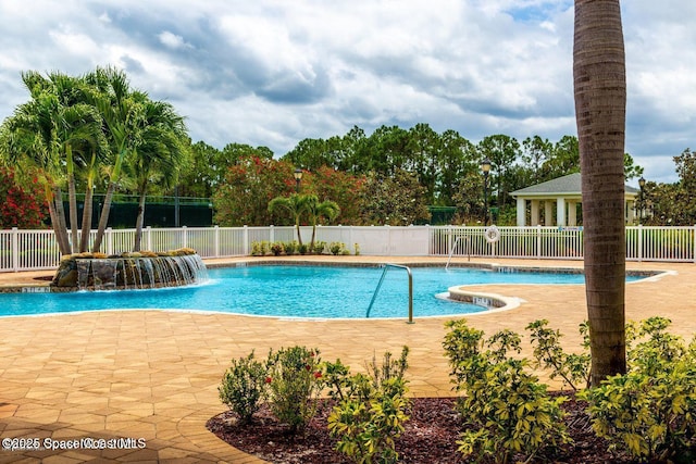 community pool featuring a patio and fence