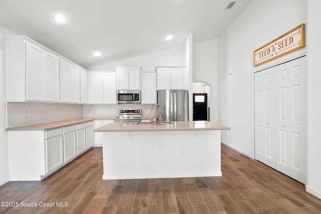 kitchen featuring stainless steel appliances, light countertops, and white cabinets