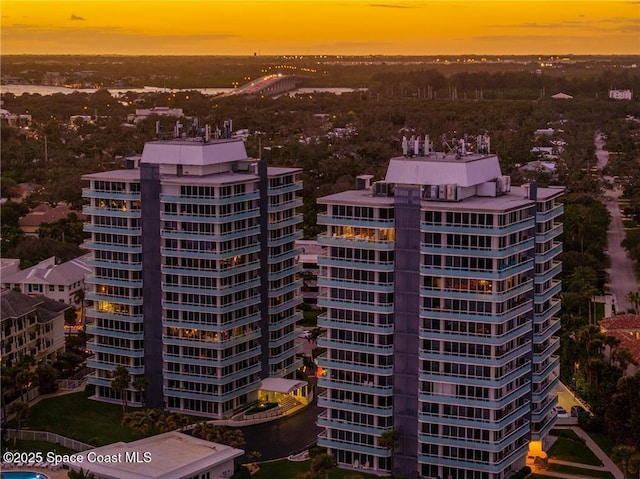 aerial view at dusk featuring a city view