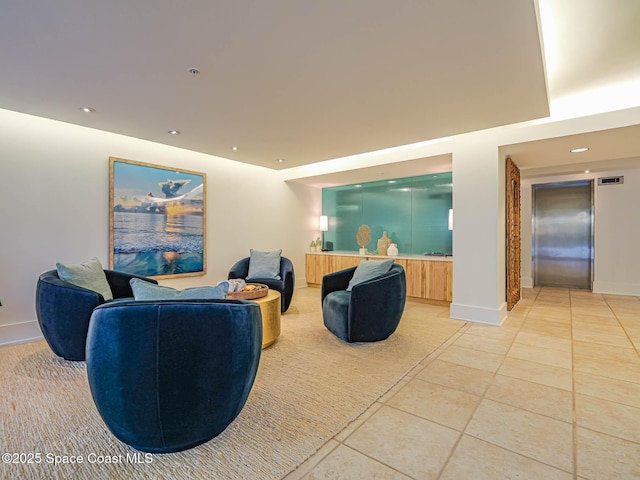 cinema with light tile patterned floors, baseboards, recessed lighting, and elevator