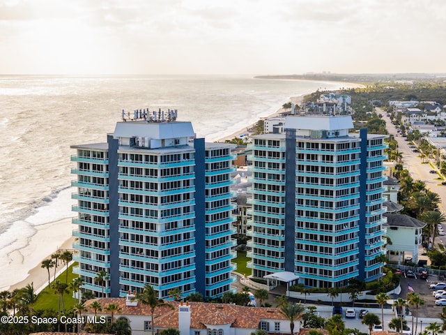 bird's eye view featuring a water view and a beach view