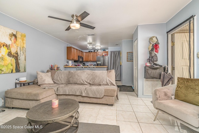 living room with ceiling fan and light tile patterned floors