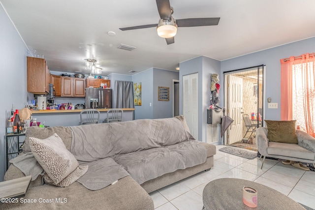 living room featuring ceiling fan and light tile patterned floors