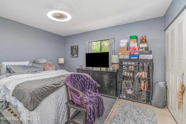 tiled bedroom with a closet