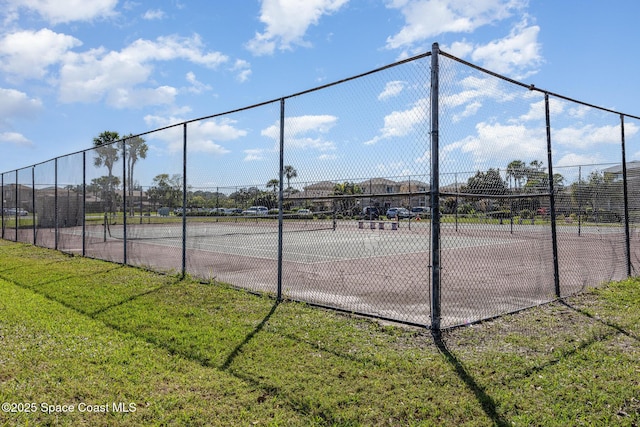 view of tennis court with a lawn